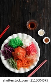 Salmon Yee Sang or Yusheng (Yu Sheng), a Chinese New Year Celebration Dish, Eat Together with Family. Top View on Wooden Table 