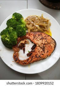 Salmon.baked Fish With Black Pepper. Brocoli Vegetables And Cooked Onions