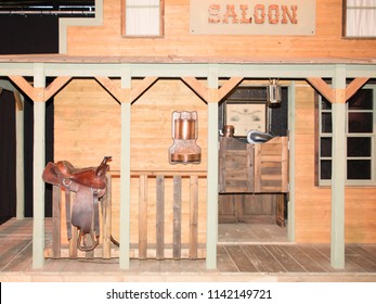 Saloon Facade In The Farwest American With A Saddle Of Horse Resting On The Ruff