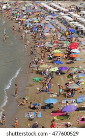SALOU, SPAIN - AUGUST 20, 2016: People relaxing and having fun on the beach to have their holidays at the coast of Salou, Spain, a famous tourist destination