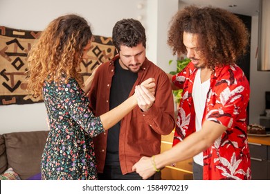 Salsa Dancing Couch Teaching A Couple Their First Lesson. 