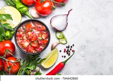 Salsa Sauce And Ingredients On Stone Table. Traditional Latin American Mexican Food. Top View With Copy Space.