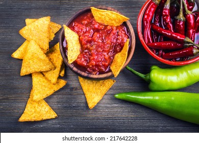 Salsa with tortilla chips and chilli peppers. - Powered by Shutterstock