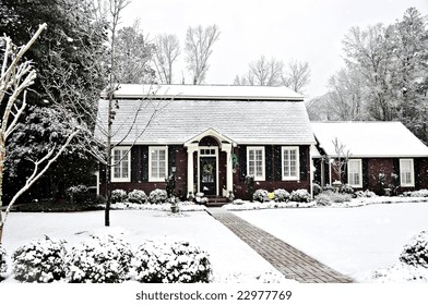 A Salt Box Style Home Covered With Fresh Snow.