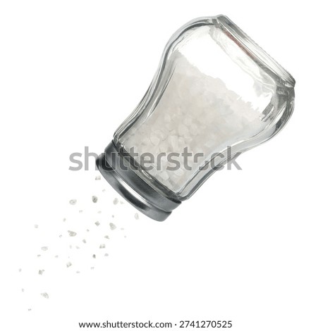 Salt falling down from shaker on white background