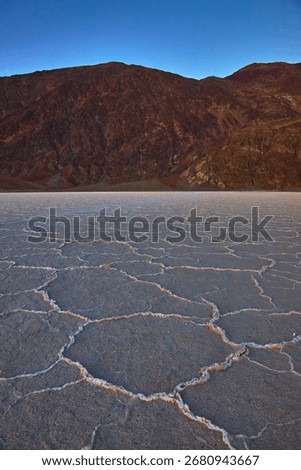 Salt Flats Pattern and Mountain Landscape at Badwater Basin Death Valley