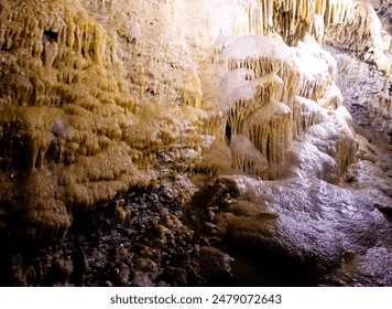 Salt formations shaped like icicles inside a rocky cave - Powered by Shutterstock