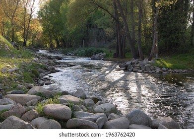 Salt, Girona, Catalonia, Spain- April 4th 2021:  River Ter By The Cycle Path From Girona To Olot In The Sun. Calm Flowing Water After Rapids Used For The ICF Freestyle Kayak World Cup In 2014. 