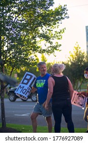 Salt Lake City, Utah / US - July 09 2020: A Woman Removes Her Mask To Spit On A Man At A Protest Outside The Salt Lake District Attorney's Office