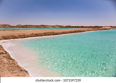 Salt Lake With Turquoise Water And White Salt On The Shore Near Siwa Oasis, Egypt