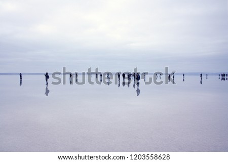 Similar – Silhouettes in low tide