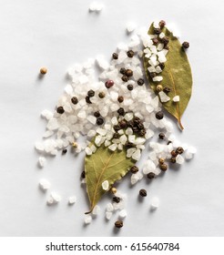 Salt And Mix Of Pepper With Bay Leaves On White Background. Top View.