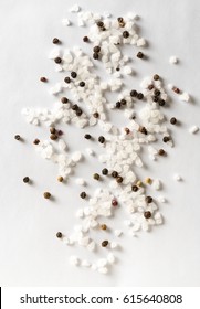 Salt And Mix Of Pepper On White Background. Top View.