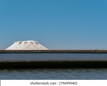 Salt Mound In A Salt Mine In Aveiro, Portugal, Against A Background Of A Completely Flat Blue Sky