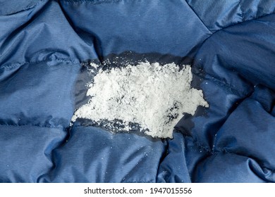 Salt On A Greasy Stain Of Clothing. Removing Oily Stains From A Down Jacket