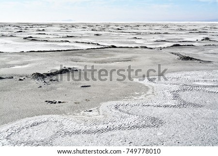 Salt patterns on the bed of the great salt lake. the level of the water changes drastically depending on the time of year and weather conditions. water here depends on snowfall in the mountains