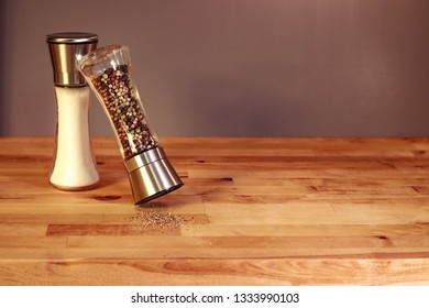 Salt And Pepper Grinders On A Butcher Block Counter