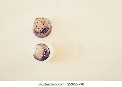 Salt And Pepper On A White Table Top View