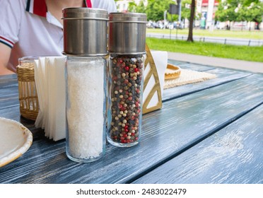 Salt and Pepper Shakers Wooden Table, Salt Container, Spices Jar, Black Pepper Bottle Shakers, Seasoning Mill, Condiments Set on Restaurant Table - Powered by Shutterstock