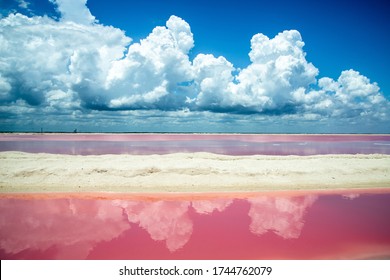 Salt pink lagoon against the blue sky with clouds reflecting in the water. Las Coloradas, Yucatan, Mexico