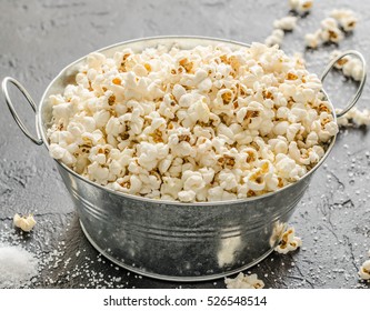 Salt Pop Corn In Metal Bowl On Black Background Close Up