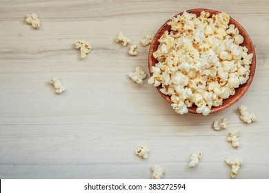 Salt Popcorn On The Wooden Table. Popcorn In A Wooden Bowl. Watching A Movie With Popcorn. Copy Space. Pop Corn. Top View. Flat Lay.