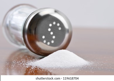 Salt Spilling On Table From Salt Cellar