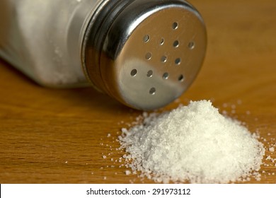 Salt Spilling On Table From Salt Cellar