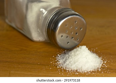 Salt Spilling On Table From Salt Cellar