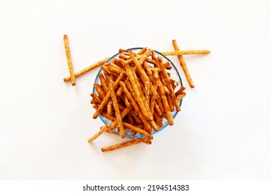  Salted Baked Brown Pretzel Sticks In Bowl On White Background Top View