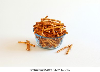  Salted Baked Brown Pretzel Sticks In Bowl On White Background 