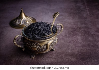 Salted Black Caviar In A Metal Dish On A Dark Stone Background. Selective Focus.