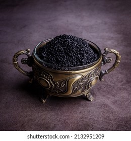 Salted Black Caviar In A Metal Dish On A Dark Stone Background. Selective Focus.