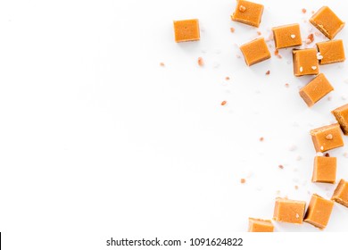 Salted Caramel. Caramel Cubes On White Background Top View Copy Space
