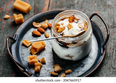 Salted Caramel Ice Cream Served In A Glass Jar On A Blue Tray, Italian Dessert Gelato,