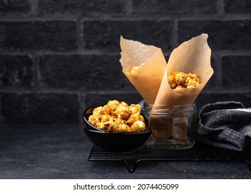 Salted Caramel Popcorn In Bowl On Dark Background