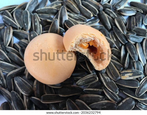 Salted egg mochi on\
top of sunflower seeds
