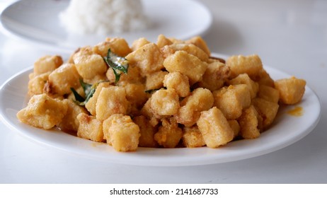 Salted Egg Sauce  Fried Tofu On A White Plate.