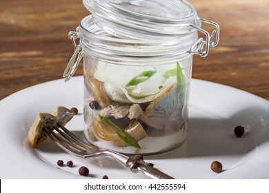 Salted Milk Mushrooms In A Glass Jar With Cream Sauce