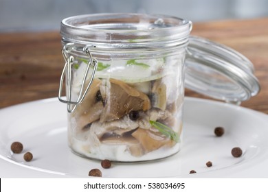 Salted Milk Mushrooms In A Glass Jar With Cream Sauce