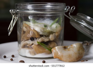 Salted Milk Mushrooms In A Glass Jar With Cream Sauce