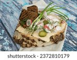 Salted planed bacon with green onions, pickles, horseradish and mustard. With rye bread. Served on a wooden saw, on a wooden table background. Rustic style. Appetizer with vodka and tincture