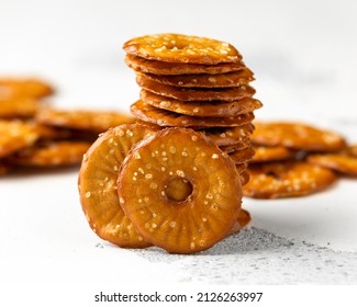 Salted Pretzel thins in black bowl on white table - Shutterstock ID 2126263997