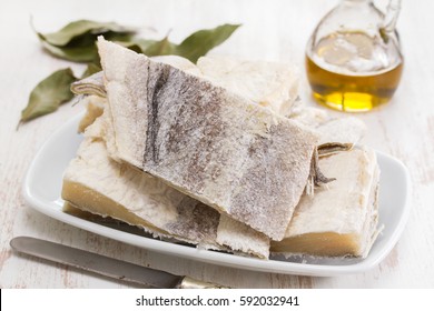 Salted Raw Dry Cod Fish On Dish And Olive Oil