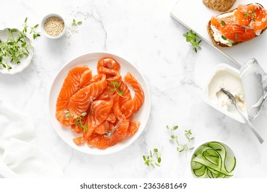 Salted salmon sliced on plate on a white background, top down view - Shutterstock ID 2363681649