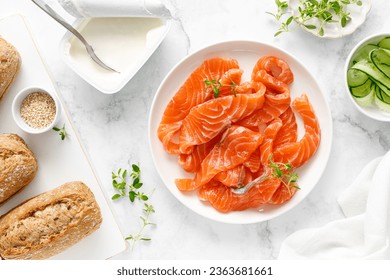Salted salmon sliced on plate on a white background, top down view - Shutterstock ID 2363681661
