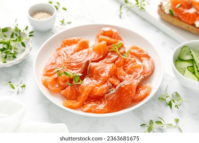 Salted salmon sliced on plate on a white background - Shutterstock ID 2363681675