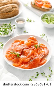 Salted salmon sliced on plate on a white background - Shutterstock ID 2363681701