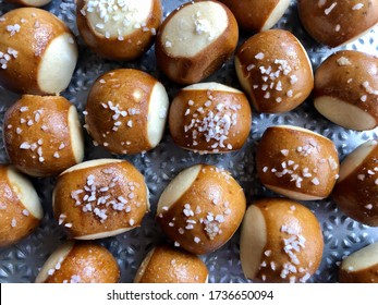 Salted Soft Pretzel Bites On A Textured Baking Sheet