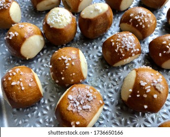 Salted Soft Pretzel Bites On A Textured Baking Sheet